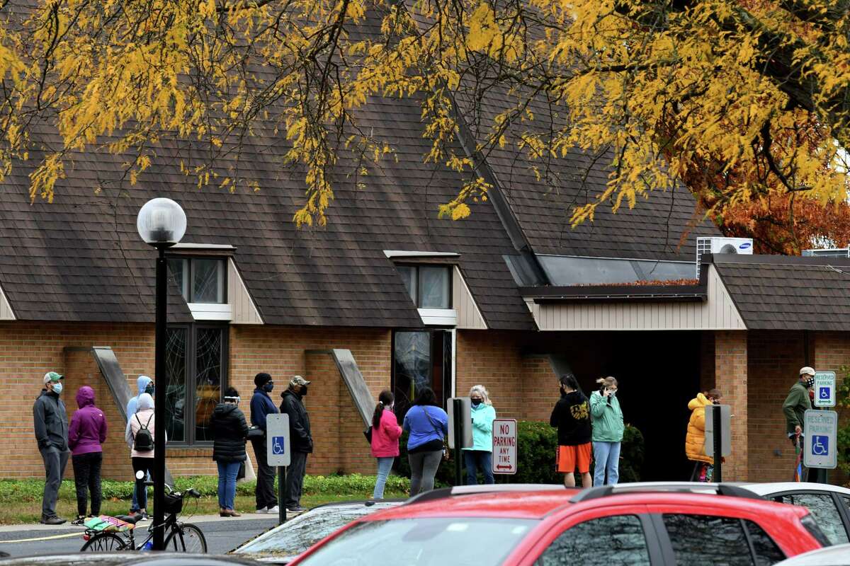 Voters stand in line at the Bethlehem Lutheran Church polling station on the first day of early voting in New York State on Saturday, Oct. 24, 2020, on Elm Avenue in Delmar, N.Y. Early voting polls are open at varying hours throughout the week until Sunday, November 1. (Will Waldron/Times Union)