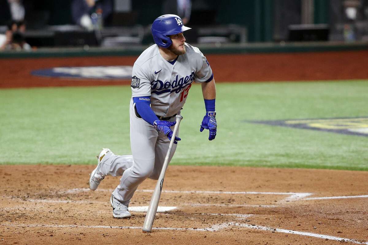 Max Muncy hits a two-run single against the Tampa Bay Rays during the third inning of Game 3 of the World Series at Globe Life Field in Arlington, Texas. Muncy had four RBIs in the first three games of the Series.