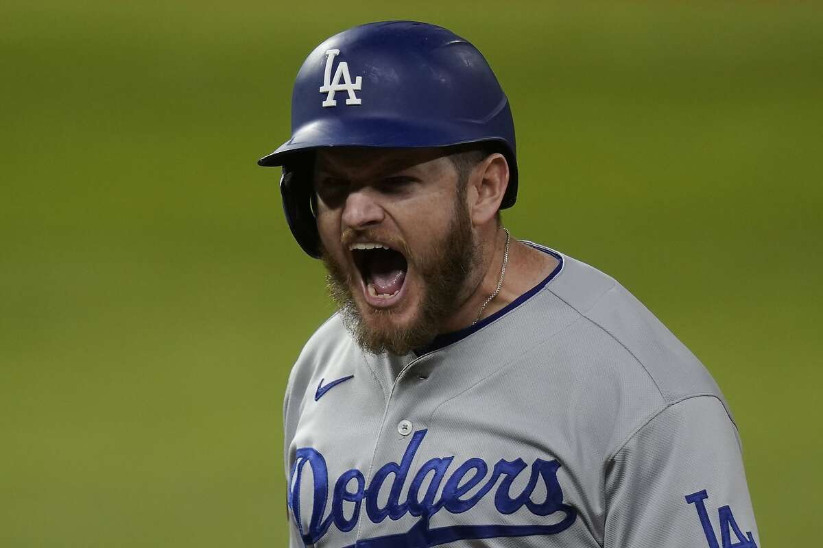 Los Angeles Dodgers' Max Muncy celebrates after two-RBI single against the Tampa Bay Rays during the third inning in Game 3 of the baseball World Series Friday, Oct. 23, 2020, in Arlington, Texas. (AP Photo/Eric Gay)