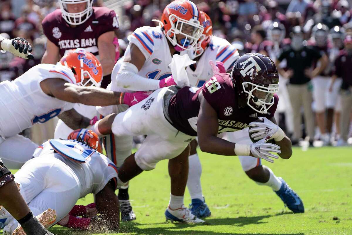 Texas A&M running back Isaiah Spiller (28) dives over the goal line for a touchdown against Florida during the second half of an NCAA college football game, Saturday, Oct. 10, 2020. in College Station, Texas. (AP Photo/Sam Craft)