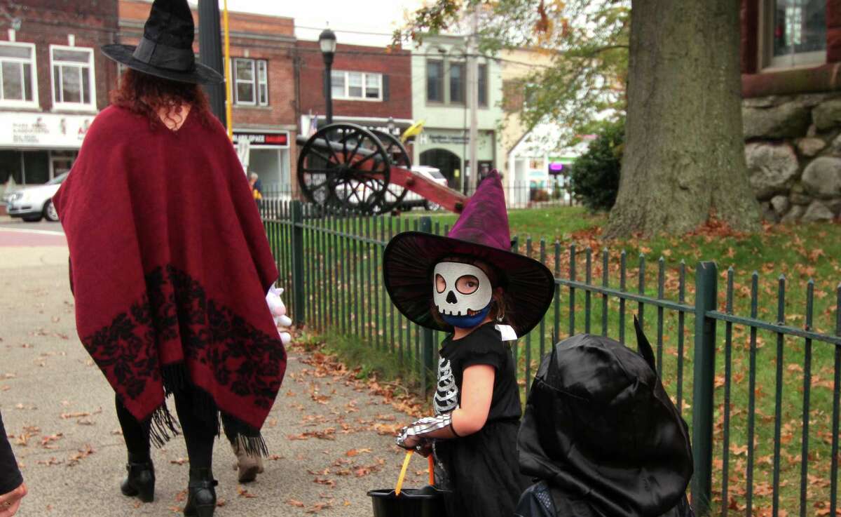 Olive McConnell, 5, of Milford,walks through downtown Milford, Conn., taking part in a safe, socially distant way to enjoy the Halloween holiday on Saturday Oct. 24, 2020. Sponsored by Spinnaker Milford, participating shops put a scarecrow out front and offered treats to local kids.