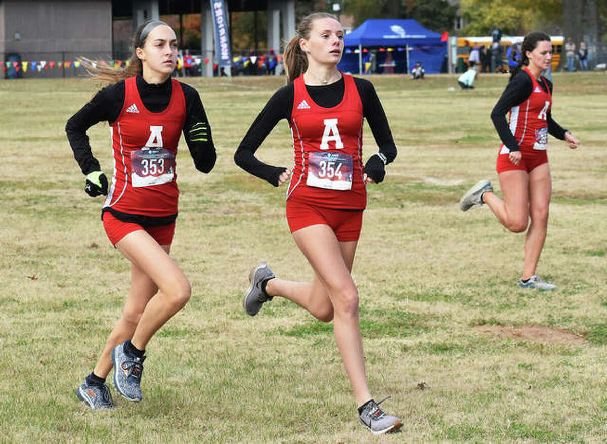 Alton’s (from left) Sophia Paschal, Alayna Rabozzi and Eva Schwaab start their race Saturday at the Granite City Class 3A Regional at Wilson Park.