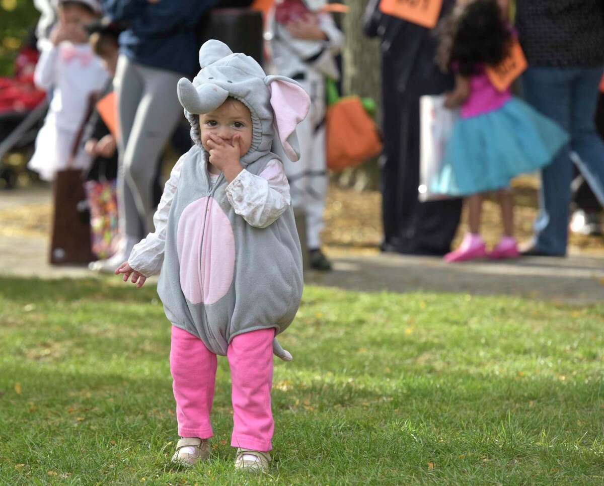 Baby elephant Adalyn Wilson, 1 1/2, of Sandy Hook, got a head start eating her Halloween candy at the 25th Halloween on the Green in 2017 in Danbury. For 2020, Danbury Mayor Mark Boughton is urging residents to leave candy outside and not to greet trick-or-treaters face to face.