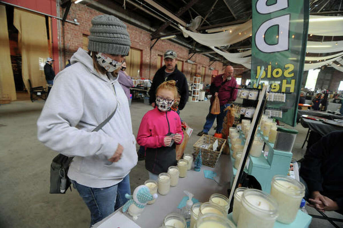 Shelby Beatty of Buffalo and her 9-year-old daughter, Emma, check out some candles at the Riverside Flea Market Sunday in Grafton.