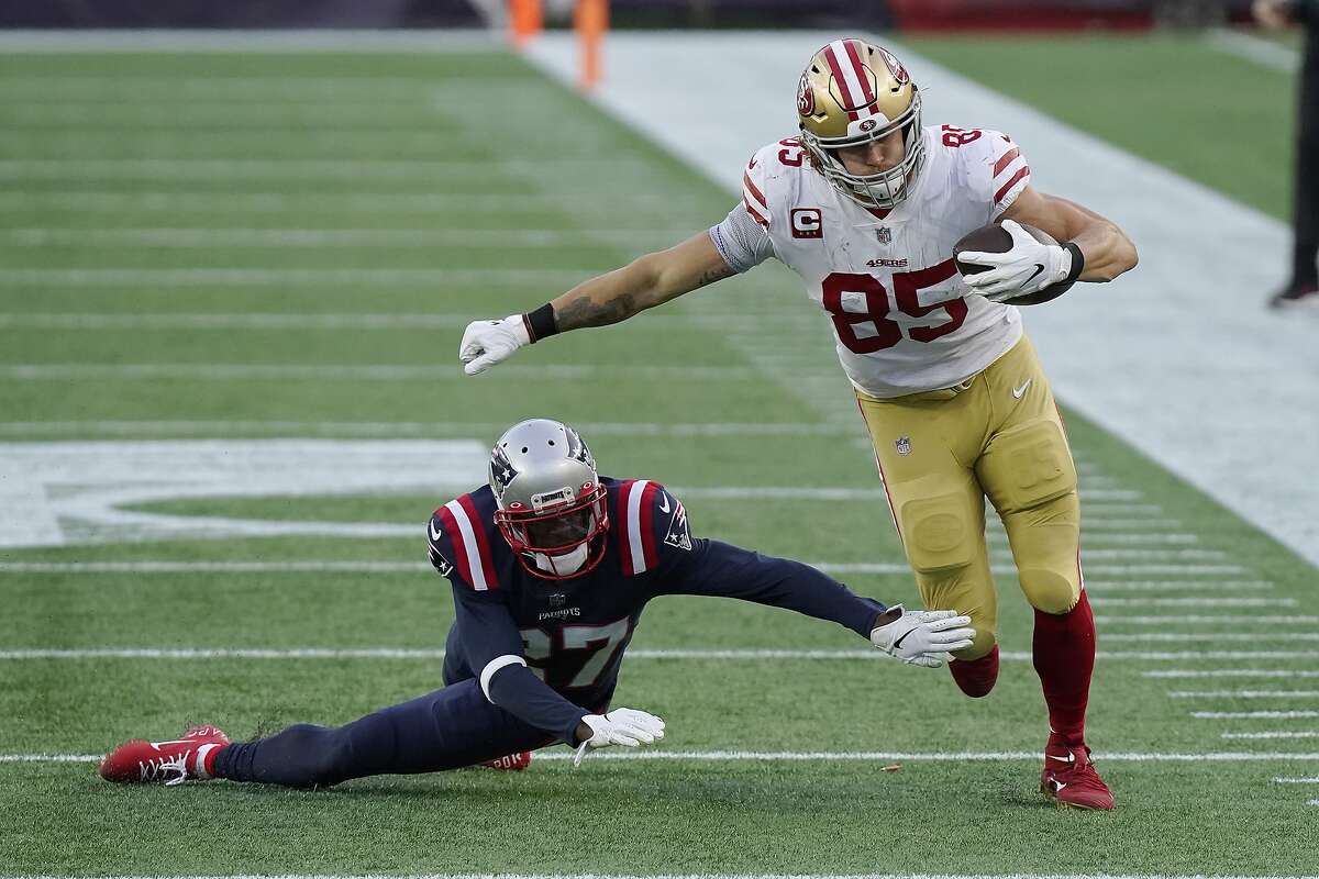 San Francisco 49ers tight end George Kittle (85) eludes New England Patriots defensive back J.C. Jackson (27) after catching a pass in the first half of an NFL football game, Sunday, Oct. 25, 2020, in Foxborough, Mass. (AP Photo/Steven Senne)