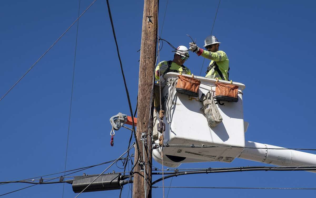 FILE - In this Oct. 25, 2019, file photo, Southern California Edison crews replace power lines that were damaged from the Tick Fire in Santa Clarita, Calif.