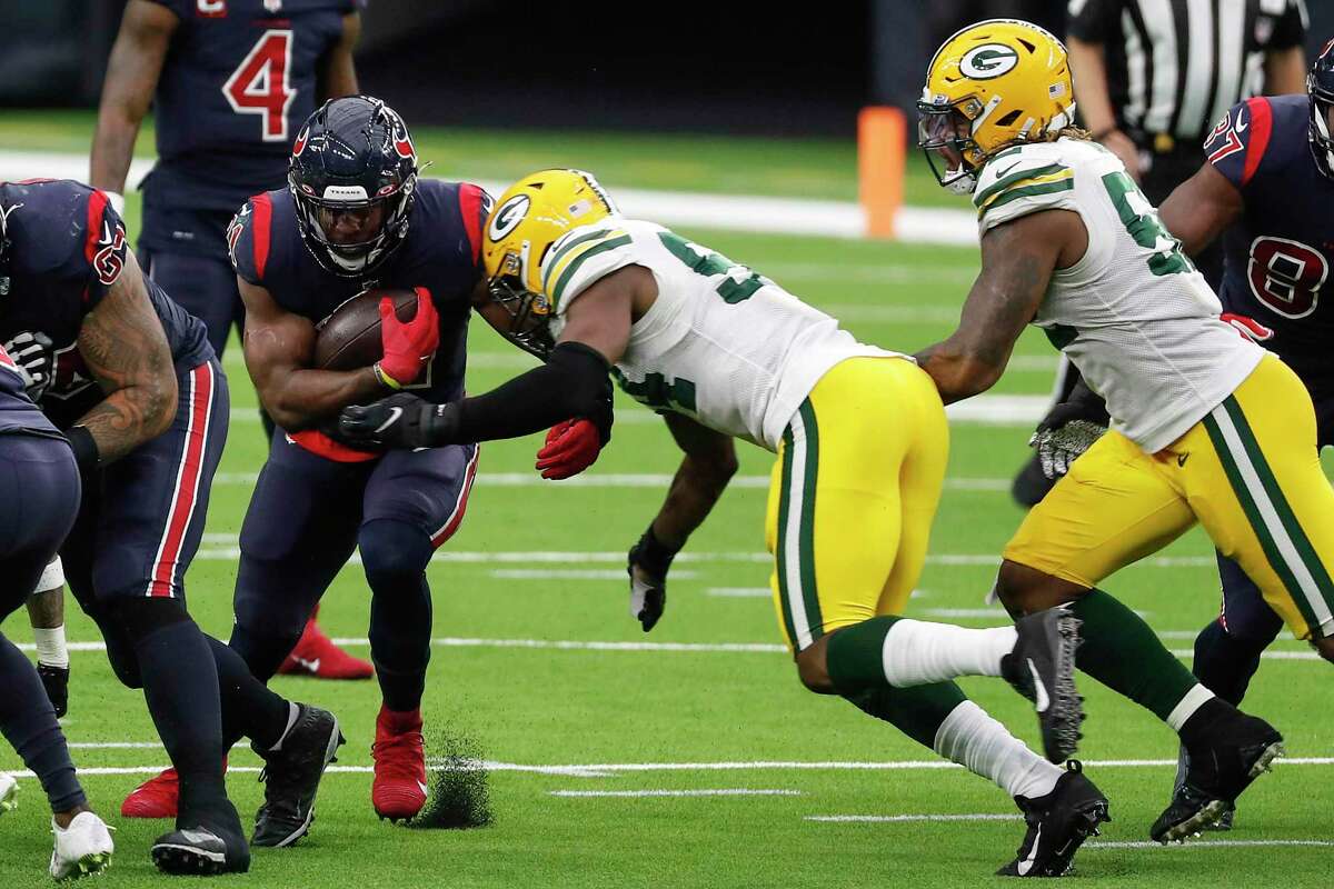 Houston Texans running back David Johnson (31) is stopped at the line of scrimmage by Green Bay Packers defensive end Dean Lowry (94) during the second half an NFL football game at NRG Stadium on Sunday, Oct. 25, 2020, in Houston.