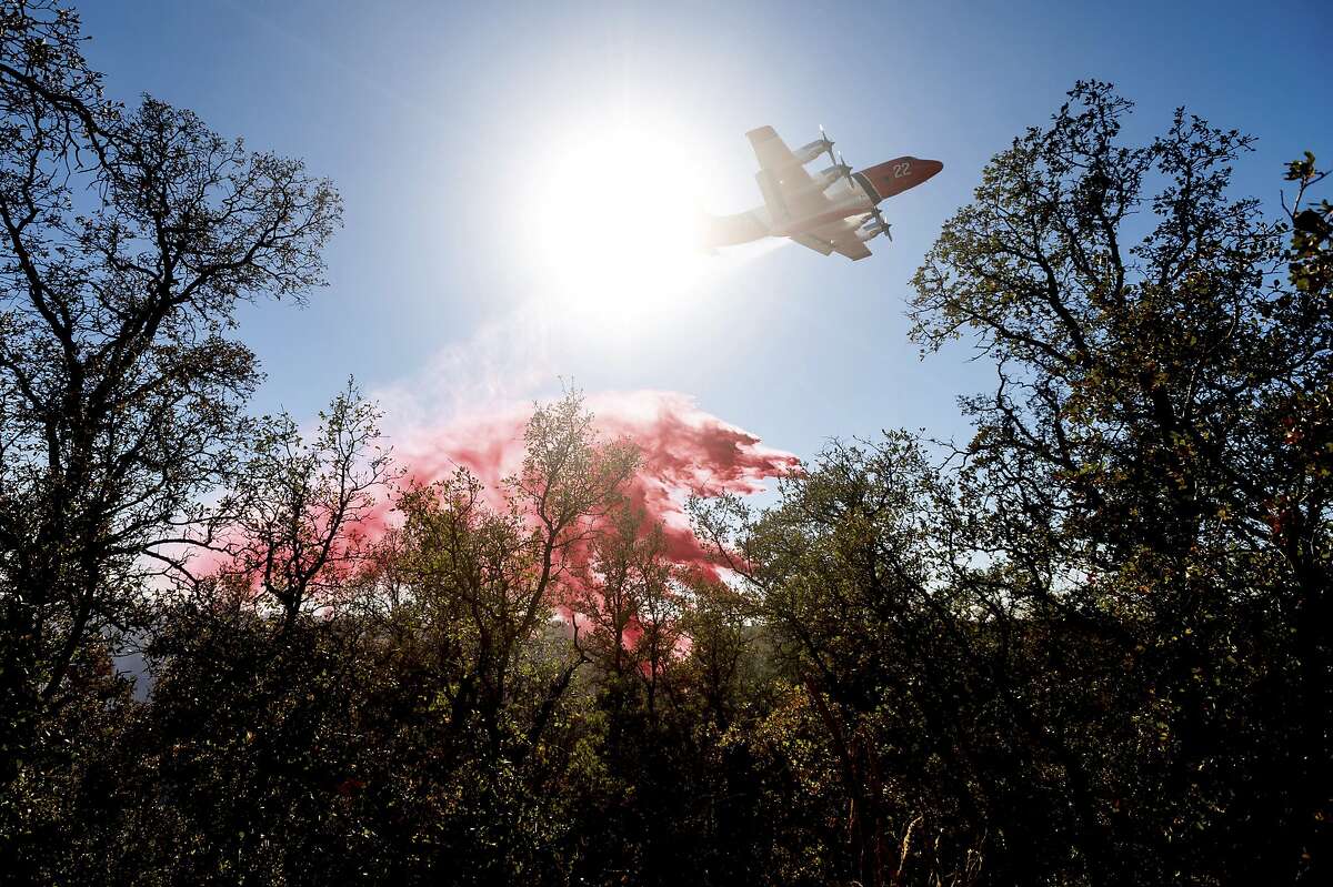 An air tanker drops retardant on the Olinda Fire in Anderson, Calif., on Sunday.The blaze was one of four fires burning near Redding that firefighters scrambled to stop as high winds buffeted Northern California.