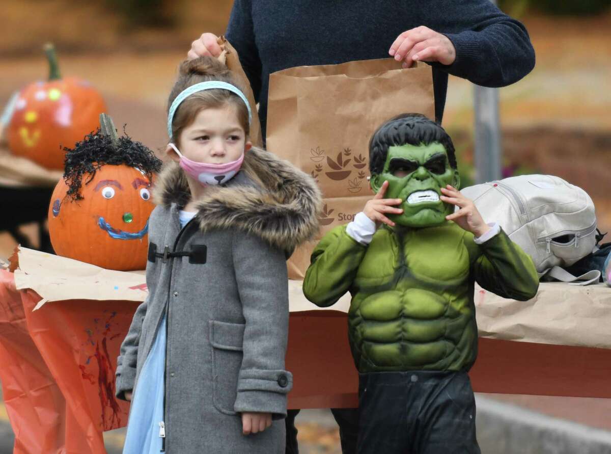 Children are dressed in costumes at the Westport Downtown Merchants Association Halloween Family Pumpkinfest in Westport, Conn. Sunday, Oct. 25, 2020. 150 families dressed in Halloween costumes participated in the socially-distant pumpkin painting event, presented by the Westport Parks & Recreation and Westport Police Athletic League in partnership with the WDMA.