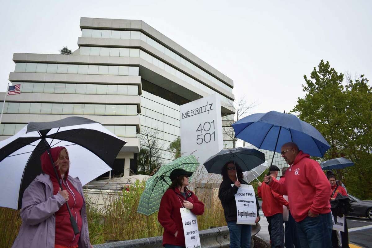 Union members demonstrate in October 2019 outside the Merritt 7 Corporate Park headquarters of Frontier Communications in Norwalk, Conn. On Monday, Oct. 26, 2020, a Frontier executive vowed to keep intact the company’s payroll of about 2,000 people through October 2021, when a contract with the Communications Workers of America is set to expire.