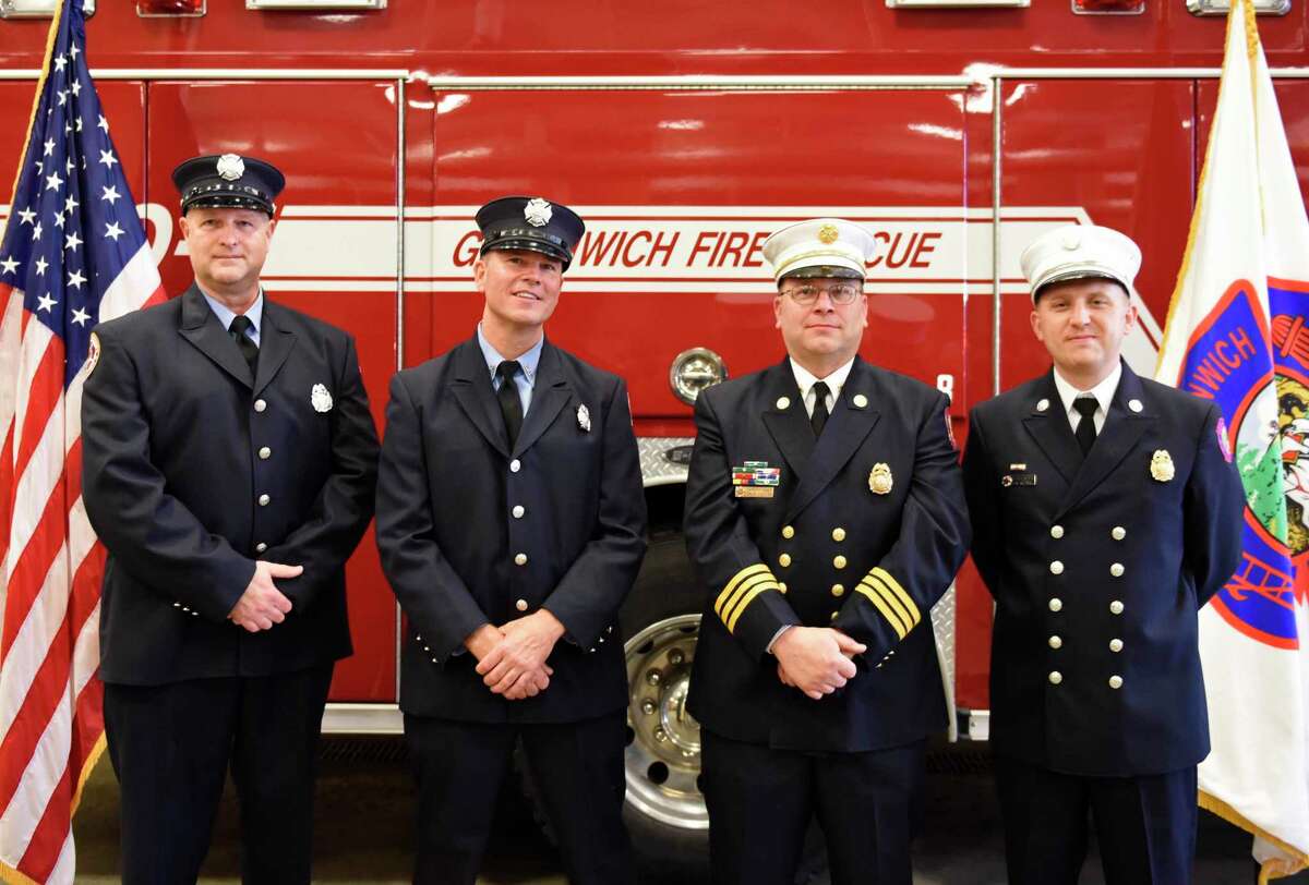 From left, Greenwich Fire Lt. Greg Sinapi, Fire Lt. Mike Wilson, Asst. Fire Chief Brian Koczak, and Deputy Fire Chief Eric Maziarz pose after being promoted at the Public Safety Complex in Greenwich, Conn. Monday, Oct. 26, 2020. “I hope I can contribute in any way I can,” he said. “And it’s been a privilege to work alongside some of the best firefighters out there.” The same year he joined the department, Maziarz suffered a knee injury and burns when he and two colleagues were forced to jump from a burning third-story building on Davis Avenue. Two new lieutenants were also given their new bars, Greg Sinapi and Mike Wilson. Wilson’s promotion went through in April, but the coronavirus pandemic prevented him from taking part in a swearing-in ceremony. Wilson has special training in confined-space operations and trench rescues, and he is a certified hazardous-material technician. He joined the department in 2000, and his father and grandfather were firefighters in Connecticut. Sinapi served as an officer with the Greenwich Police Department, from 2000 to 2005. He studied landscape architecture at the University of Rhode Island, and he is on the department’s scuba-diving team. Sinapi is also a state fire investigator. “They’re going to serve this town admirably,” Fire Chief Joseph McHugh, who was himself sworn into the department’s top leadership position in late summer, said of the newly promoted officers. First Selectman Fred Camillo told them “You have our thanks for the many years of service, and we look forward to many, many more.” rmarchant@greenwichtime.com