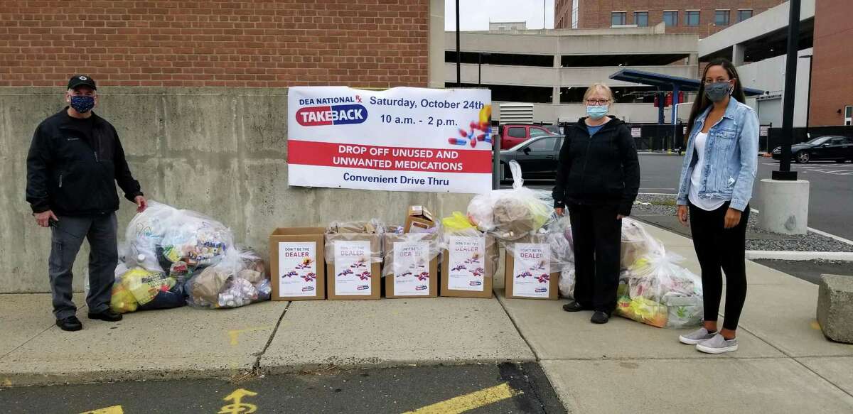 Capt. Richard Conklin (left) standing across from Ingrid Gillespie, director of prevention at Liberation Programs Inc., and (far right) Daniella Arias, program manager at The Hub, the Behavioral Health Action Organization for Southwestern Connecticut. The group collected a record 699 pounds of unwanted superscription drugs.