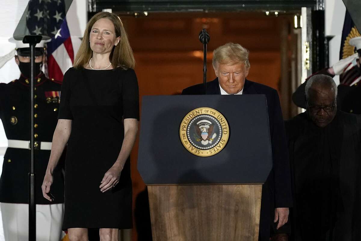 President Donald Trump and Amy Coney Barrett arrive on the South Lawn of the White House White House in Washington, D.C., after Barrett was confirmed to be a Supreme Court justice by the Senate earlier in the evening.