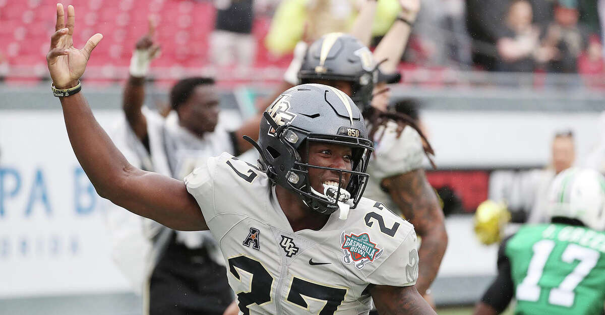 UCF defensive back Richie Grant (27) celebrates after a touchdown after an interception during the Gasparilla Bowl game of UCF versus Marshall at Raymond James Stadium in Tampa, Fla., on Monday, Dec. 23, 2019. UCF won, 48-25. (Stephen M. Dowell/Orlando Sentinel/TNS)