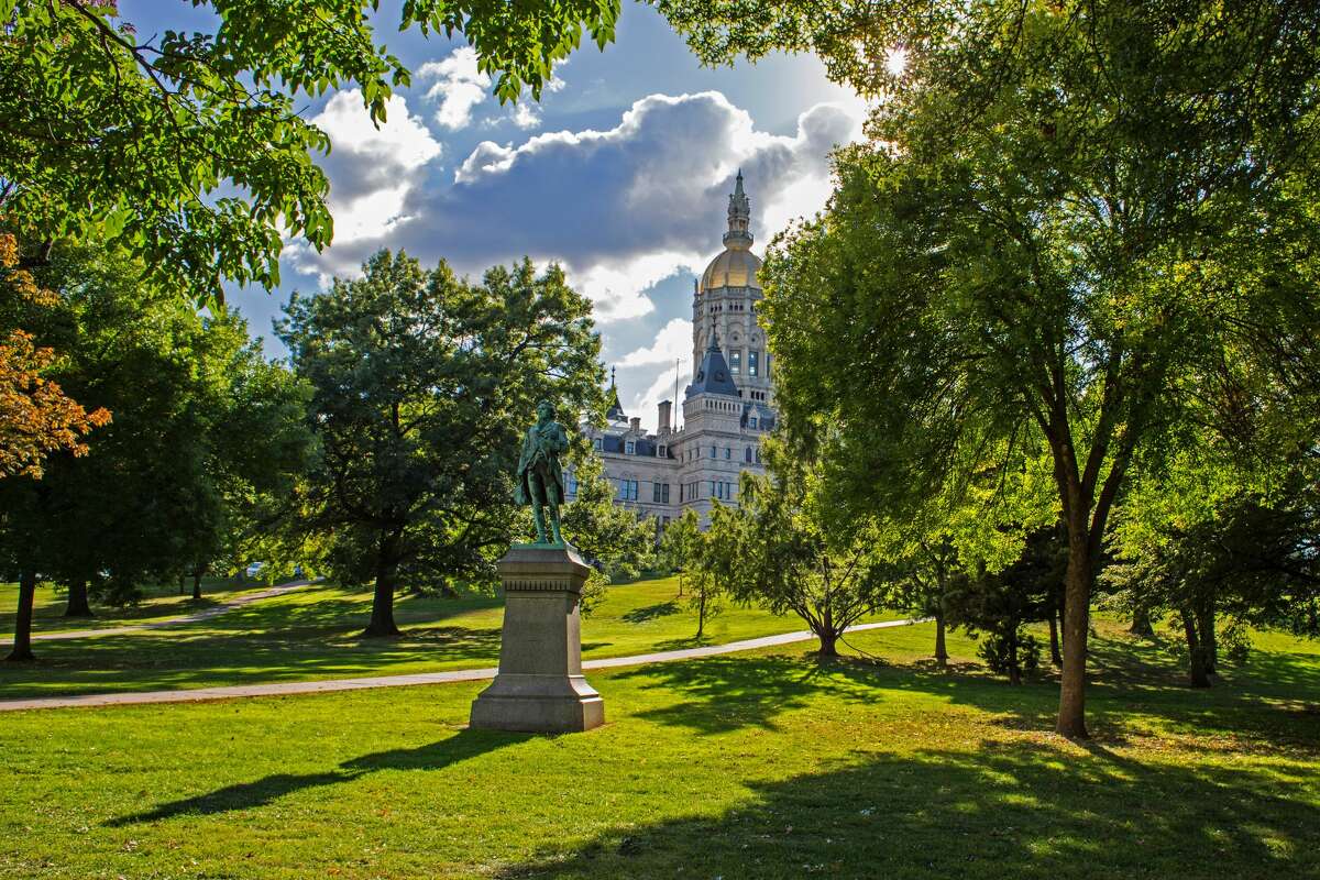 An artistic shot into the sun showing historic Capitol building located in downtown Hartford, CT. View is taken from Bushnell Park.