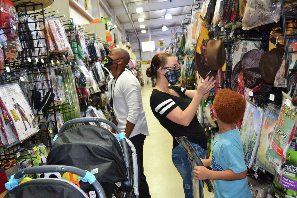 The Kay family, including Damerick, left, Kayla and Kori look through costumes in preparation for the Halloween holiday. Kori selected a Harry Potter costume for his night out on the town.