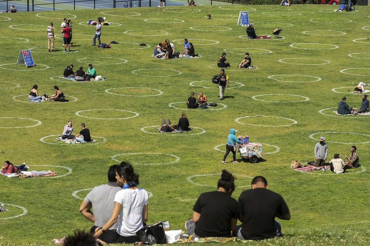The physical distancing circles at Dolores Park are one measure San Francisco has taken to contain the coronavirus. Cases in Texas have passed those in California, despite Texas’ smaller population.