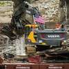 Workers with Fisher Contracting continue removing pieces of debris from the Sanford Dam Tuesday, Oct. 27, 2020 in downtown Sanford. (Katy Kildee/kkildee@mdn.net)