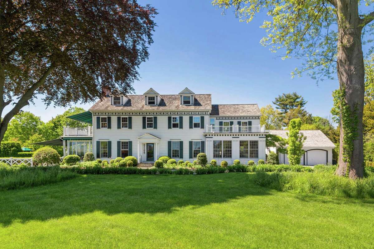 The colonial house at 1252 Pequot Avenue was built in 1929 for relaxed beachside living as well as living and entertaining in grand style, which still holds true today. “There are views of Long Island Sound from almost every room,” the agents said, including the master bedroom suite, which features a private deck with a retractable awning, “where you can escape your busy household and take in the view, sunshine and lovely ocean breezes. On sunny, summer afternoons you will enjoy watching the sailing regattas from the porch and the private deck off the master bedroom,” they said. In addition to the 5,044 square feet of formal and casual elegance offered in this 12-room house, the two-acre level property features gorgeous perennial and rose gardens, a vegetable garden, a culinary herb garden just off the kitchen and an exterior garden room with walls of tall privet hedges. Border gardens of hydrangeas and white irises line the semi-circular driveway, and at least one tree on the broad front lawn sits in a circlet of wildflowers reminiscent of London’s Hyde Park.