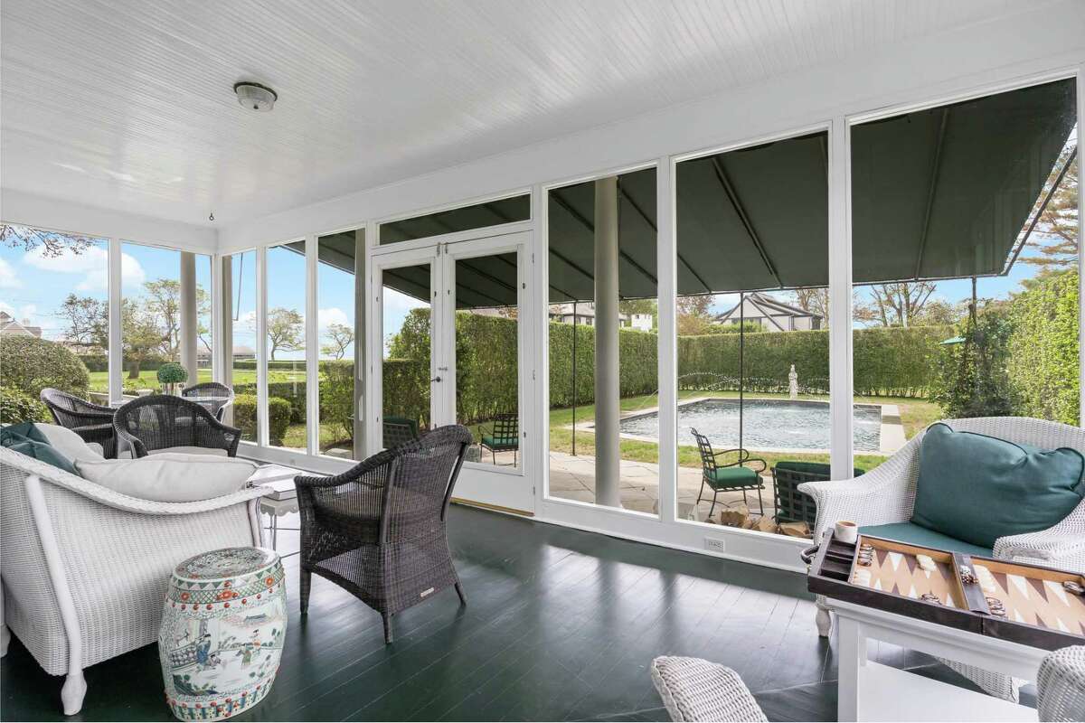 The sizable screened porch has views of the pool and Long Island Sound. Inside, this house features a classic layout with generously proportioned rooms, tall ceilings and large windows. The banquet-sized dining room is adjacent to the sizable updated eat-in country kitchen, which features a marble center island, glass-front cabinetry, pantry, high-end stainless appliances, built-in desk area and breakfast room. Fireplaces are found in the spacious formal living room and sunken family room. The house has a total of six bedrooms, four on the second floor and two on the third level.