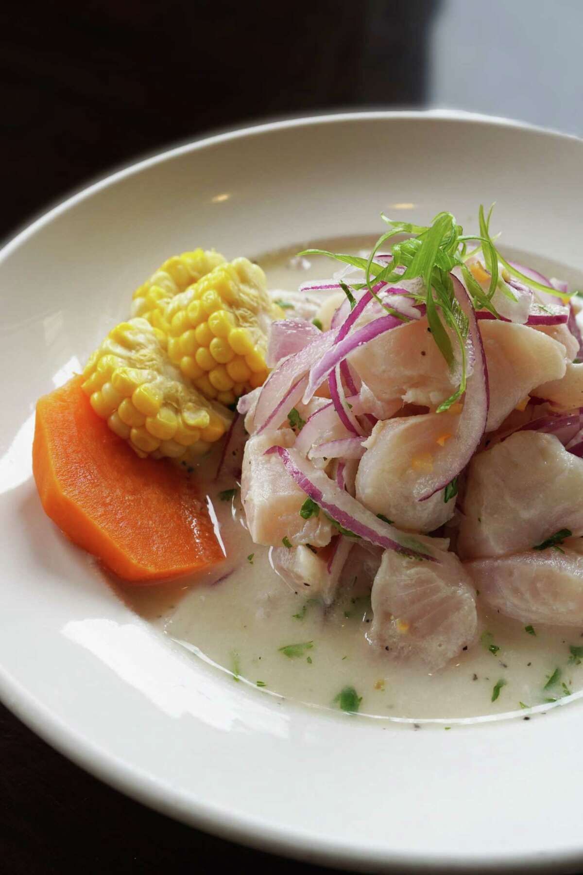 Peruvian ceviche, bathed in leche de tigre, is a signature dish at Latin Bites Kitchen on Woodway.