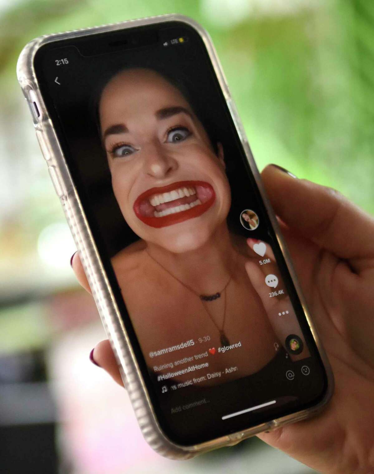 TikTok star Samantha Ramsdell plays her most viewed TikTok video on her phone at her home in Stamford, Conn. Tuesday, Oct. 27, 2020. Ramsdell has amassed more than 500,000 followers on TikTok under the user name @samramsdell5 since pivoting to the mobile video app early in the pandemic.