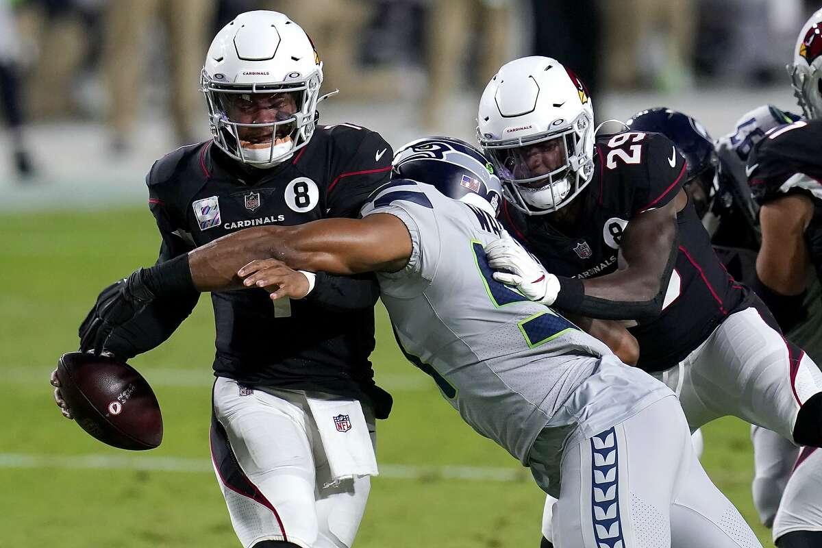 Arizona Cardinals quarterback Kyler Murray avoids the sack as Seattle Seahawks middle linebacker Bobby Wagner, right, makes the hit during the first half of an NFL football game, Sunday, Oct. 25, 2020, in Glendale, Ariz. (AP Photo/Ross D. Franklin)