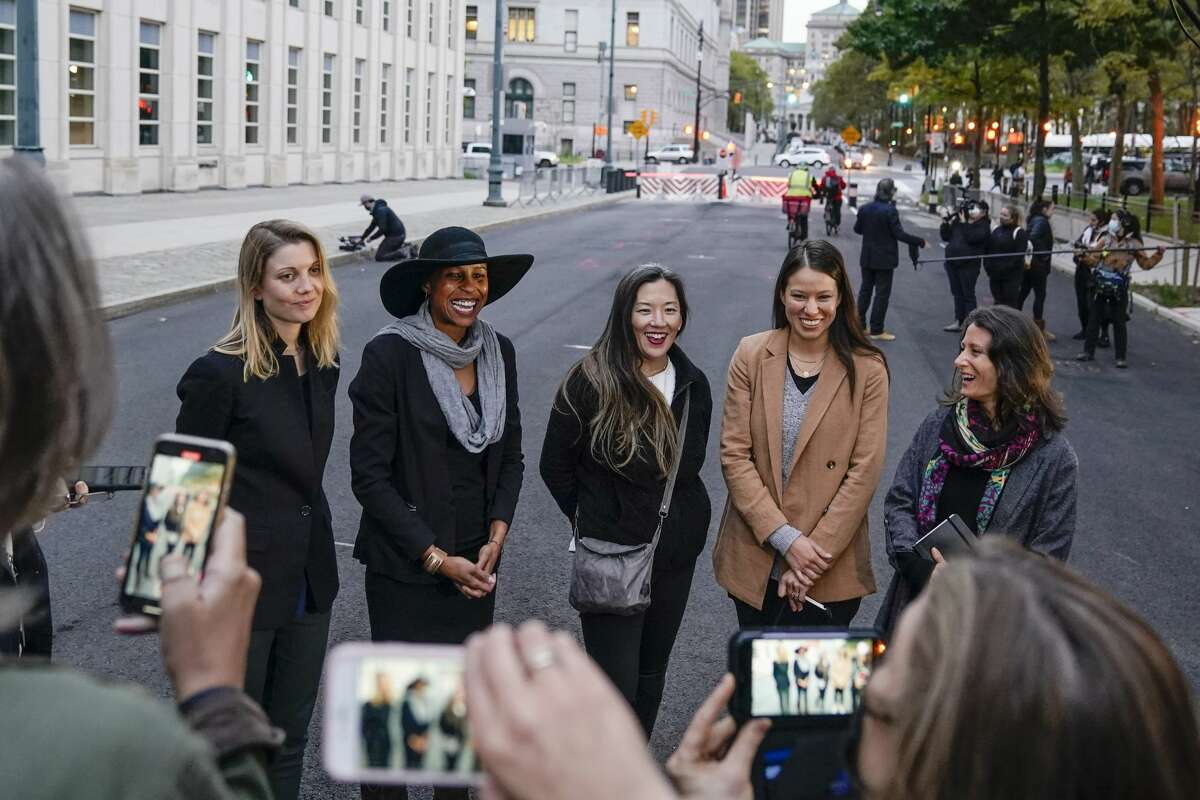 Nicki Clyne, left, Michelle Hatchette, second from left, Linda Chung, center, and Dr. Danielle Roberts, right, speak outside Brooklyn federal court following the sentencing hearing for self-improvement guru Keith Raniere Tuesday, Oct. 27, 2020, in New York. Raniere, the NXIVM leader, was sentenced to 120 years. (AP Photo/Frank Franklin II)