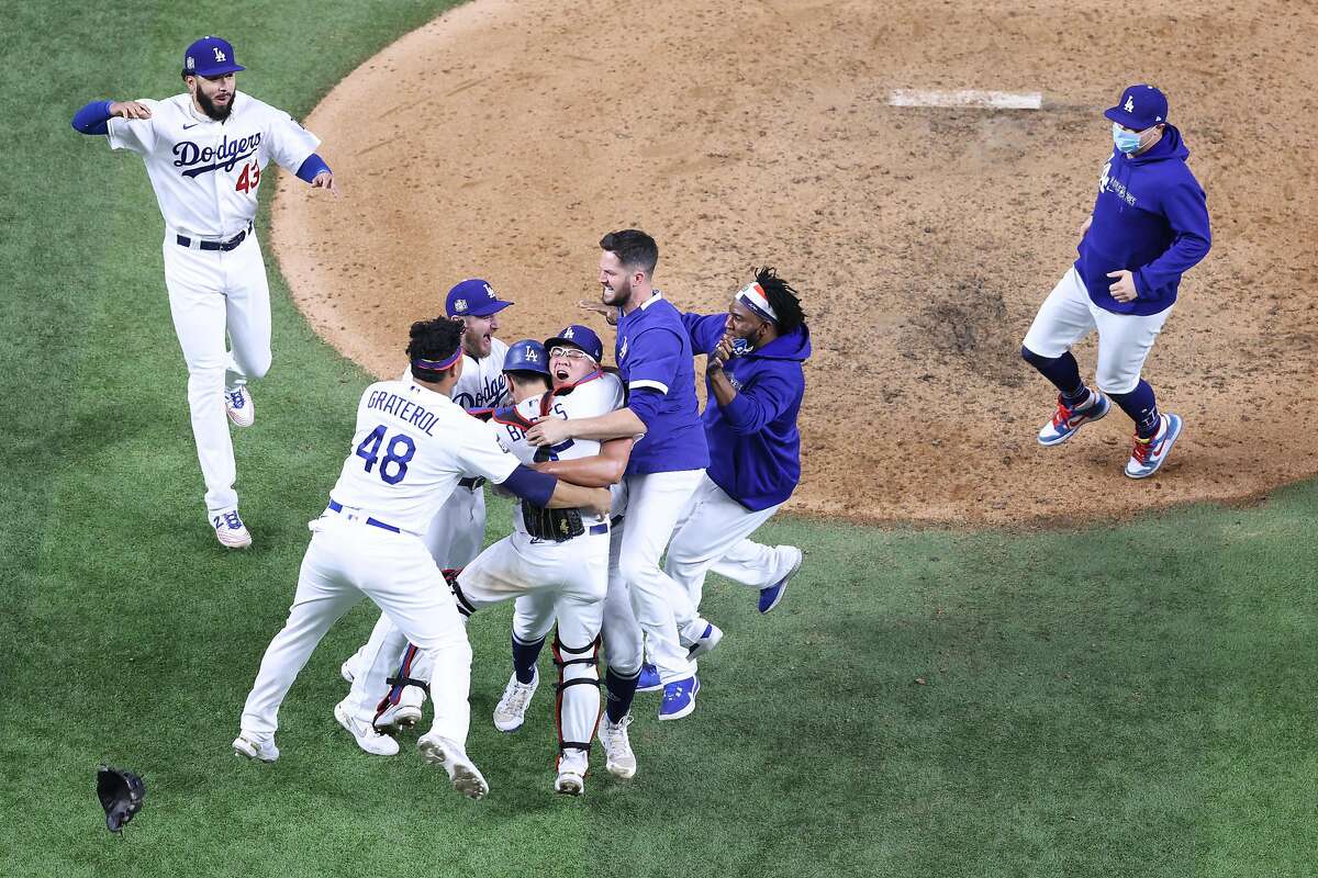 ARLINGTON, TEXAS - OCTOBER 27: The Los Angeles Dodgers celebrate after defeating the Tampa Bay Rays 3-1 in Game Six to win the 2020 MLB World Series at Globe Life Field on October 27, 2020 in Arlington, Texas. (Photo by Maxx Wolfson/Getty Images)