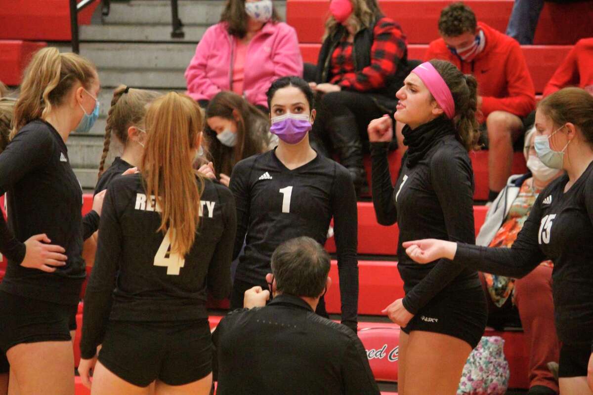 Reed City volleyball players receive instructions from coach Don Patterson in last week's match with Fremont. (Herald Review photo/John Raffel)