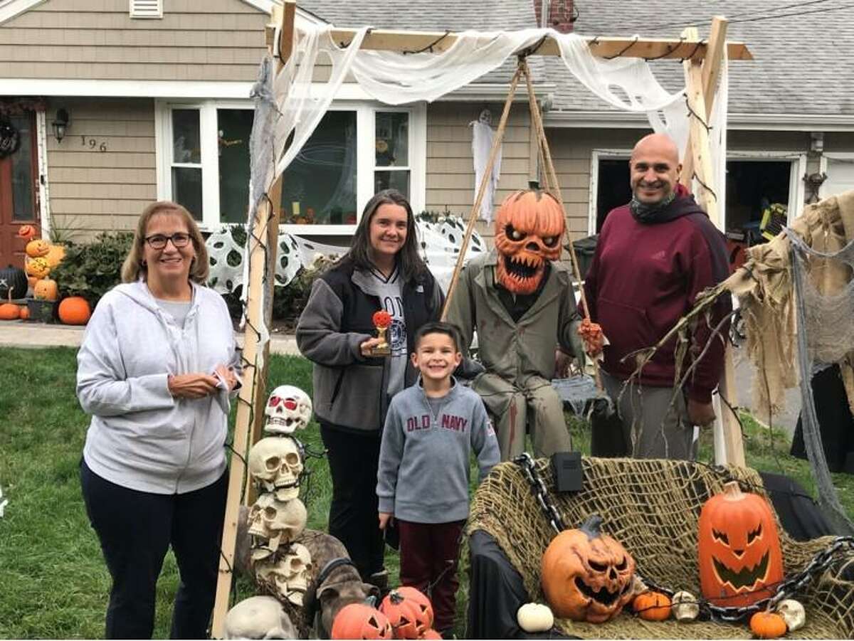 Three Trumbull families recently received gift cards and trophies as part of the Trumbull Community Women Halloween House Decorating Contest. The contest had 26 entries. Scariest: 196 Sterling Road, Rich and Kim Roldan; Most Whimsical: 21 Lantern Hill, Tiffany Eastman and Todd Gagner; and Best Homemade Decorations, 10 Fox Court, Sandy Shilling. Contest chairman Loretta Chory delivered the prizes.