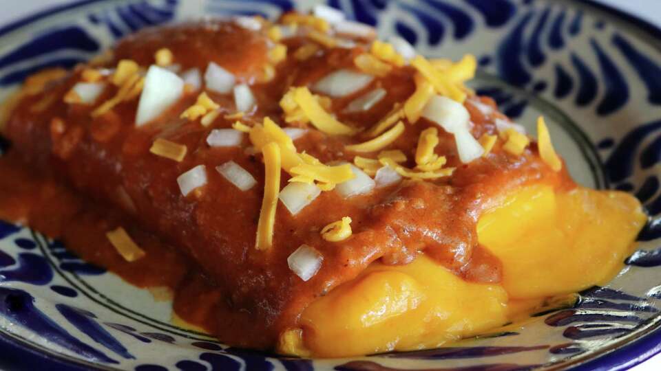 Enchilada Queen Sylvia Caseres' cheese enchiladas with chili gravy are among nearly two dozen enchiladas available at Sylvia's Enchilada Kitchen.