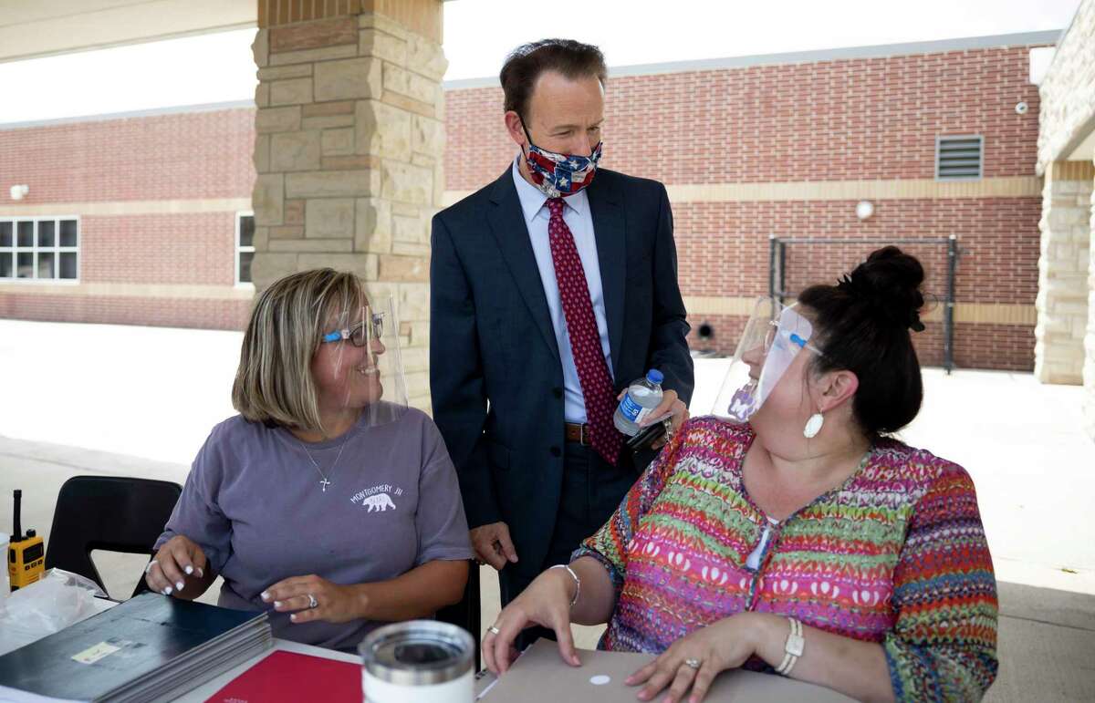 Montgomery ISD Superintendent Heath Morrison speaks with Amy Stanley, left and Barbara Gagliano, right, at Montgomery Junior High School in August. The Montgomery Independent School District’s Board of Trustees has extended COVID-19 paid leave for the remainder of the school year.
