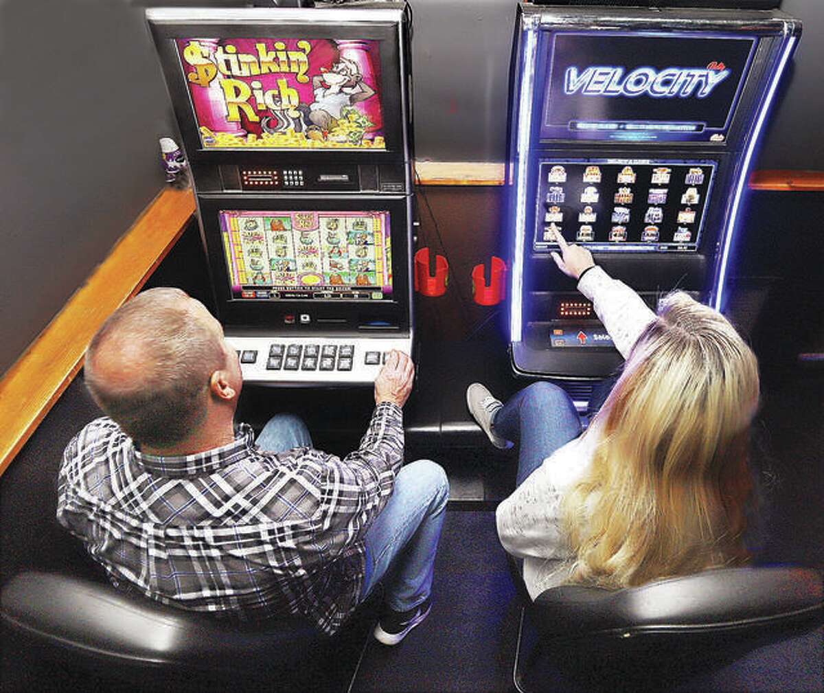 Two gamblers try their luck on the slot machines inside Bubby and Sissy’s bar on Belle Street in Alton. The Glen Carbon Board of Trustees voted to pass an ordinance to allow video gaming Tuesday, allowing video gaming systems similar to these in specific establishments.