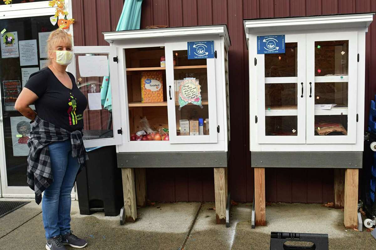 Tracie Killar, director of the South End Children's Cafe, stands next to the free food pantries outside the South End Children's Cafe on Wednesday, Oct. 28, 2020 in Albany, N.Y. (Lori Van Buren/Times Union)