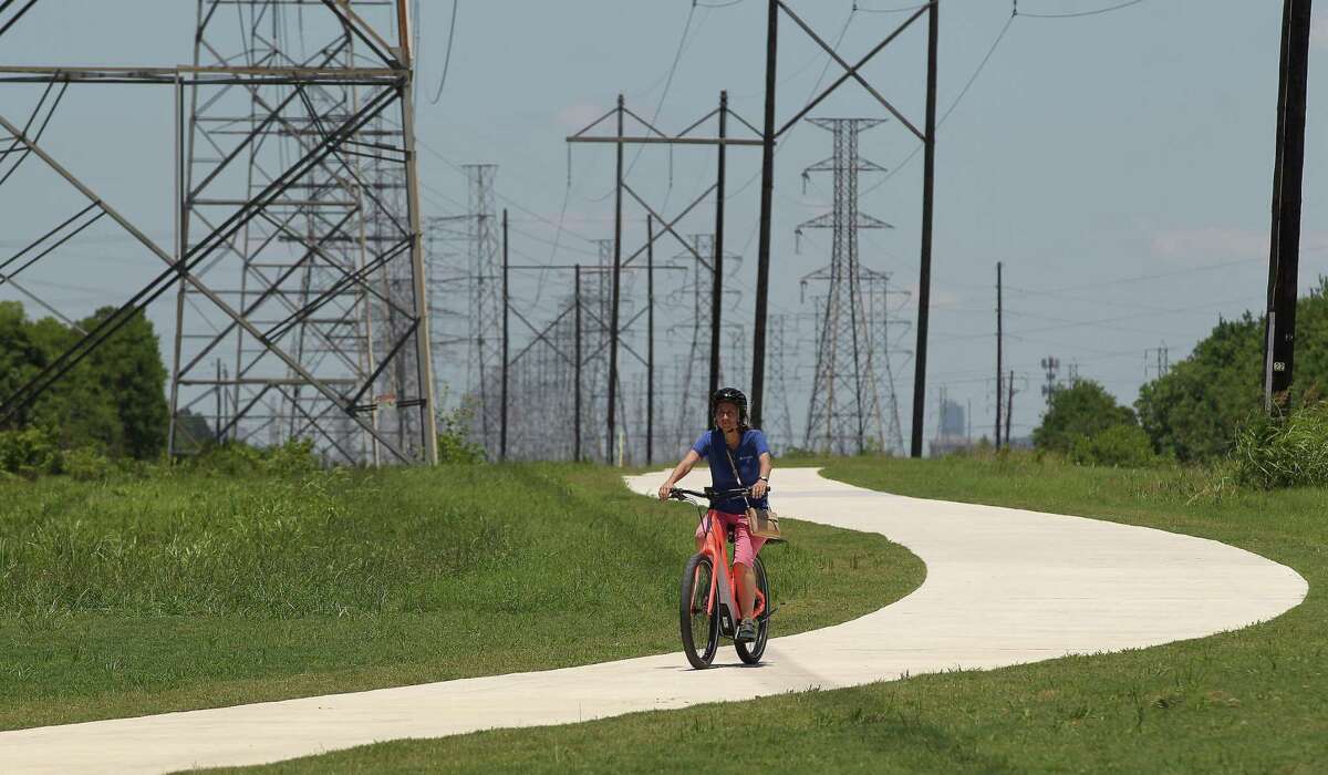 Janice Kruse rides on the new recreational trail along CenterPoint Energy easement on June 8, 2019, in southwest Houton near Hiram Clarke.