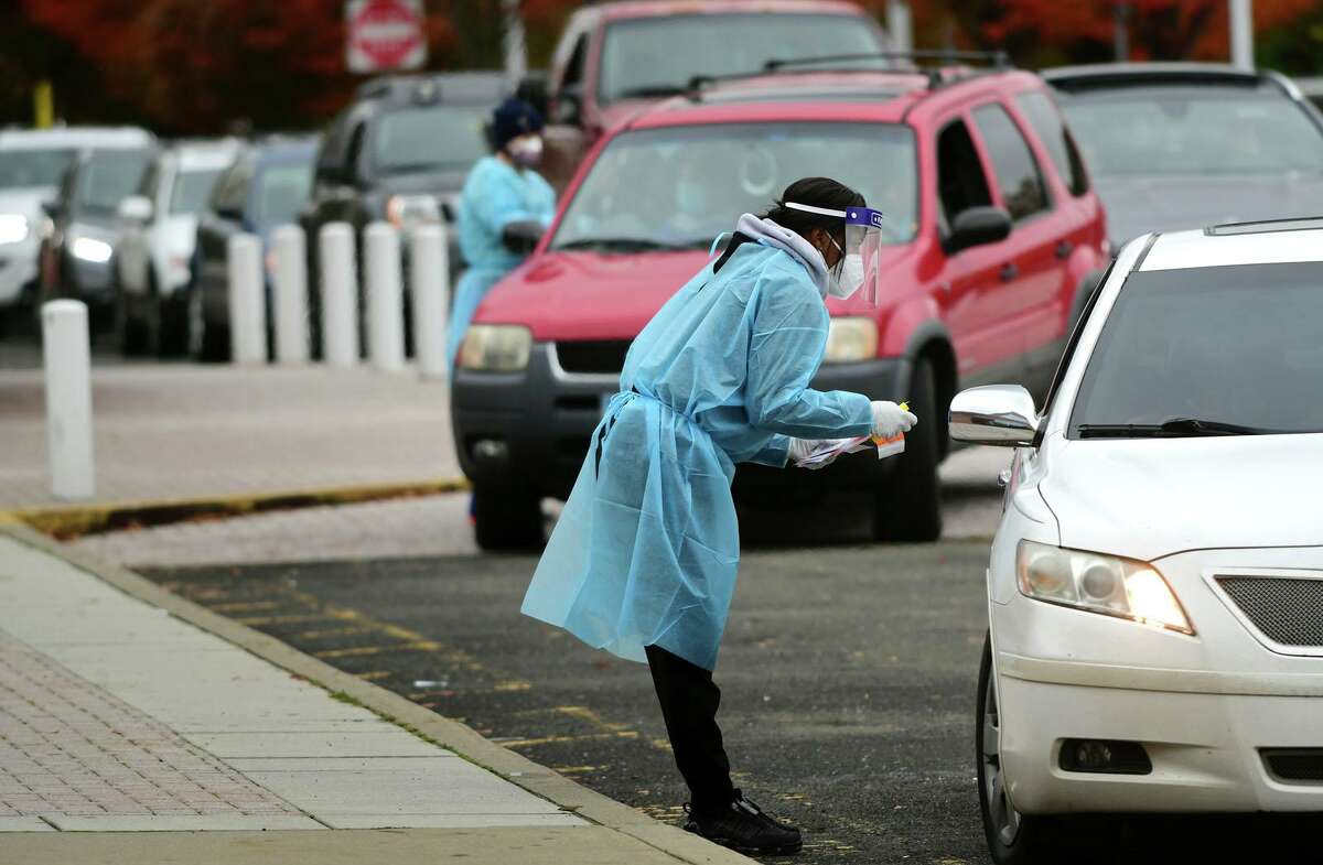 Day Street Community Health Center staff conduct drive-thru coronavirus testing Wednesday, Octoer 28, 2020, at Brien McMahon High School in Norwalk, Conn.