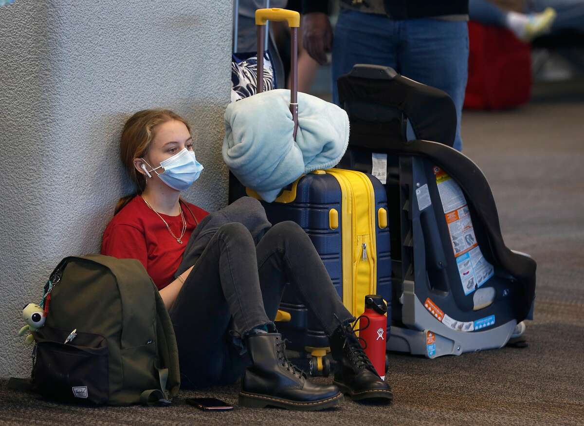 Pamela Larson, 16, waits to board a flight home to Honolulu at SFO in San Francisco, Calif. on Thursday, Oct. 15, 2020. As the airline industry sees a modest rise in travel, a rapid COVID-19 testing site has been set up at the airport to provide travelers with documentation of test results to present upon arrival at their final destinations.