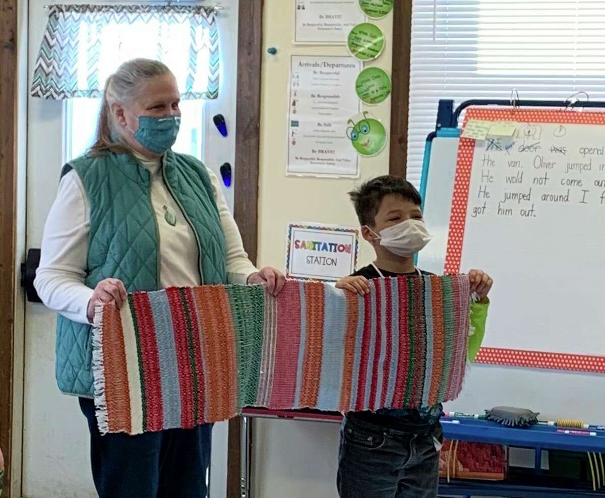 Lake County Historical Museum Curator Jill Engelman (left) presents Leon Burns from Big Jackson School, with the woven runner he helped create. (Submitted photo)