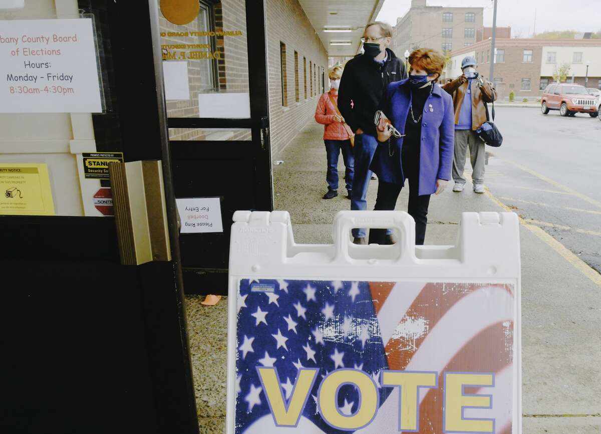 Albany Mayor Kathy Sheehan and her husband Robert Sheehan wait to enter the Albany County Board of Elections to cast their ballots in early voting on Wednesday, Oct. 28, 2020, in Albany, N.Y. (Paul Buckowski/Times Union)