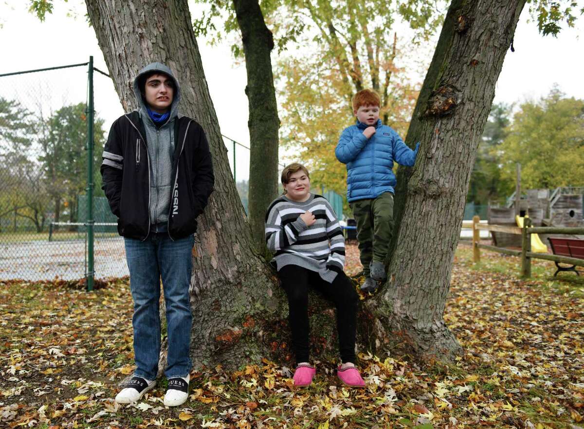 Hubbard Day School students Giovanni Nozzolini, 16, of Colchester, Sydney Iannuzzi, 14, of Wilton, and Max Garan, 9, of Greenwich, pose outside Hubbard Day School in Greenwich, Conn., photographed on Monday, Oct. 26, 2020.