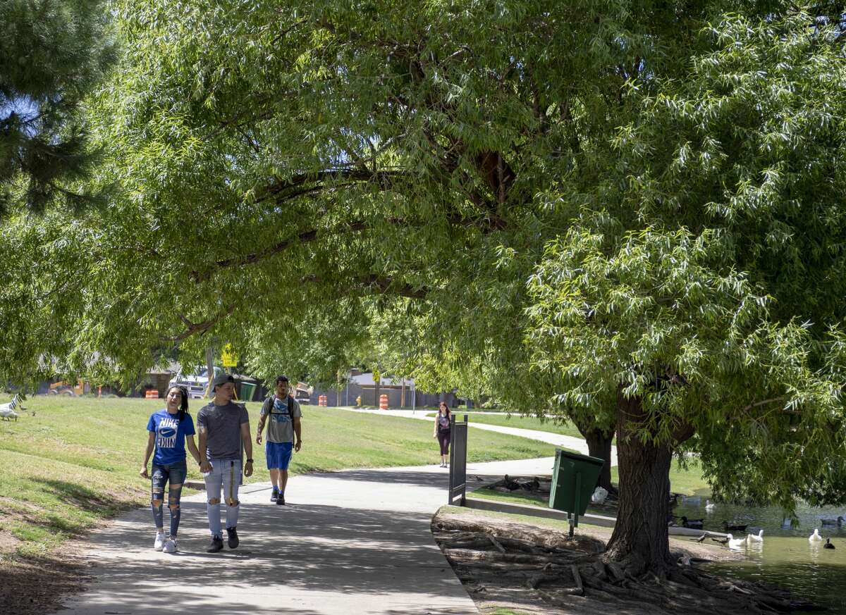 Walkers stroll around Wadley Barron Park on June 6, 2019. Studies have shown that residents are happy with their city if they have opportunities for chance encounters – such as might occur at a local park.