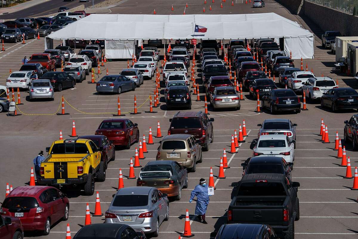Motorists line up for coronavirus tests at the University of El Paso. That city is a hot spot.