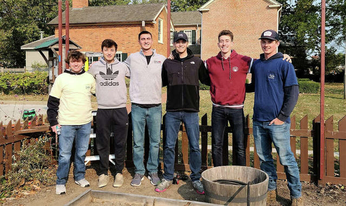 Members of Southern Illinois University Edwardsville’s Sigma Phi Epsilon fraternity work on beautifying the gardens at 1820 Col. Benjamin Stephenson House Saturday. Members of Southern Illinois University Edwardsville’s Sigma Phi Epsilon fraternity pose in the garden.