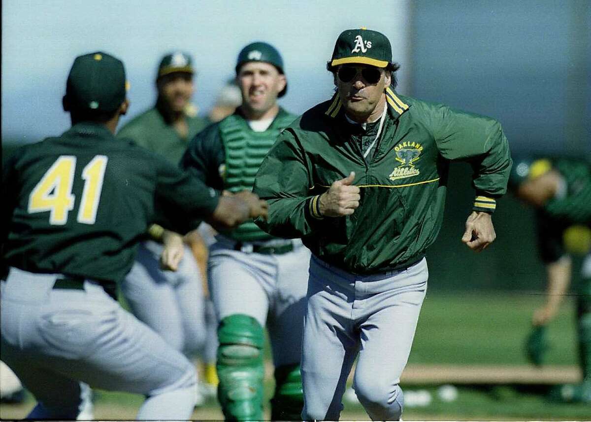 Baseball Spring Training: Oakland A's manager Tony La Russa tries to avoid the tag of Fausto Cruz during team run down drills.