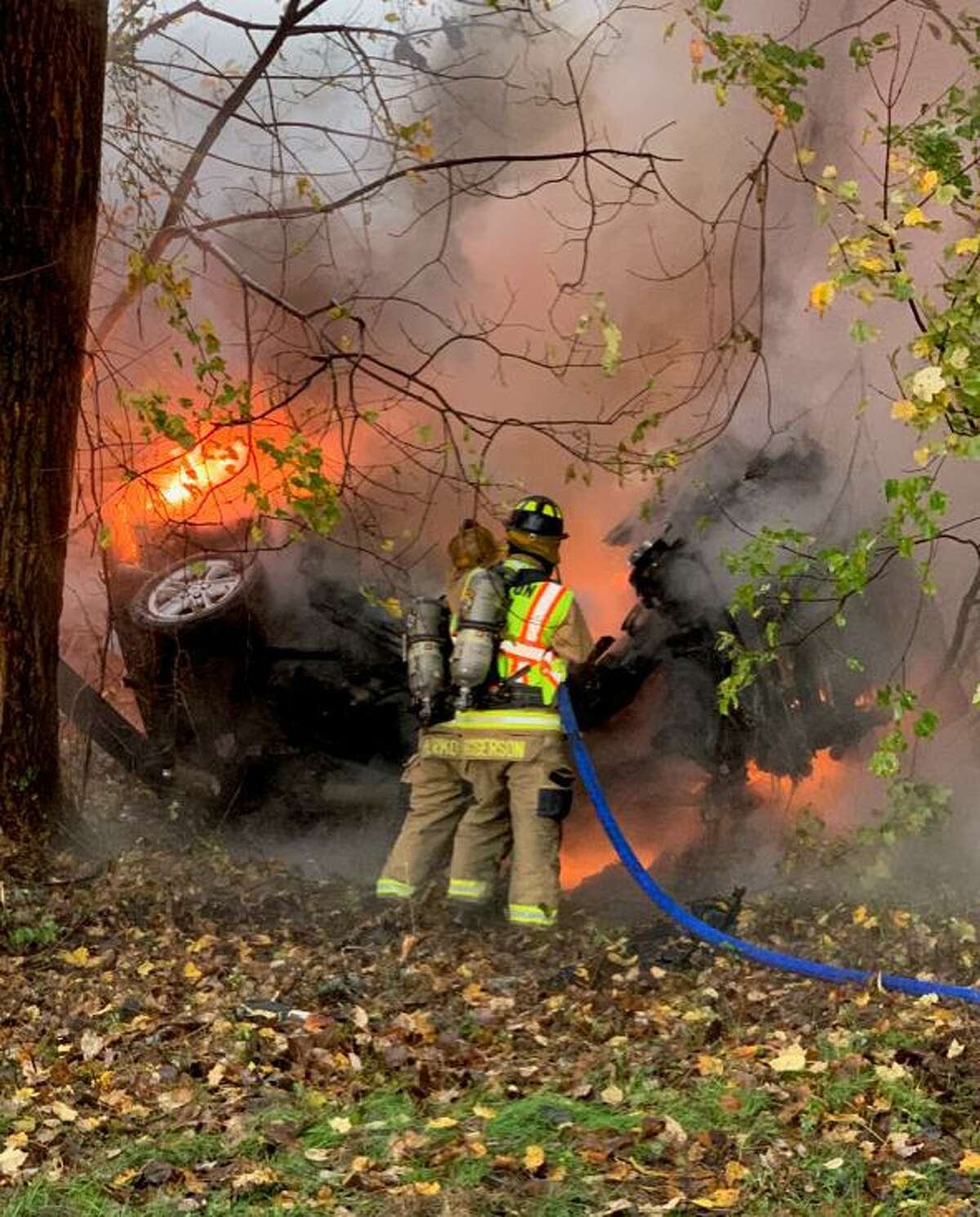 Shelton firefighters work on a car fire on Route 8 southbound between exits 12 and 13 on Thursday, Oct. 29.