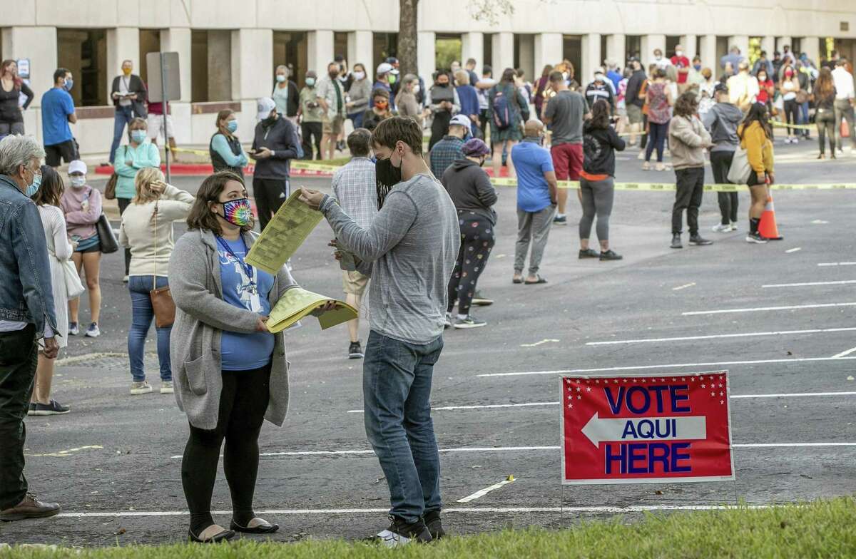 People wait in a long line on October 13, 2020, to vote at an early voting location at the Renaissance Austin Hotel in Austin, Texas. (Jay Janner/Austin American-Statesman/TNS)