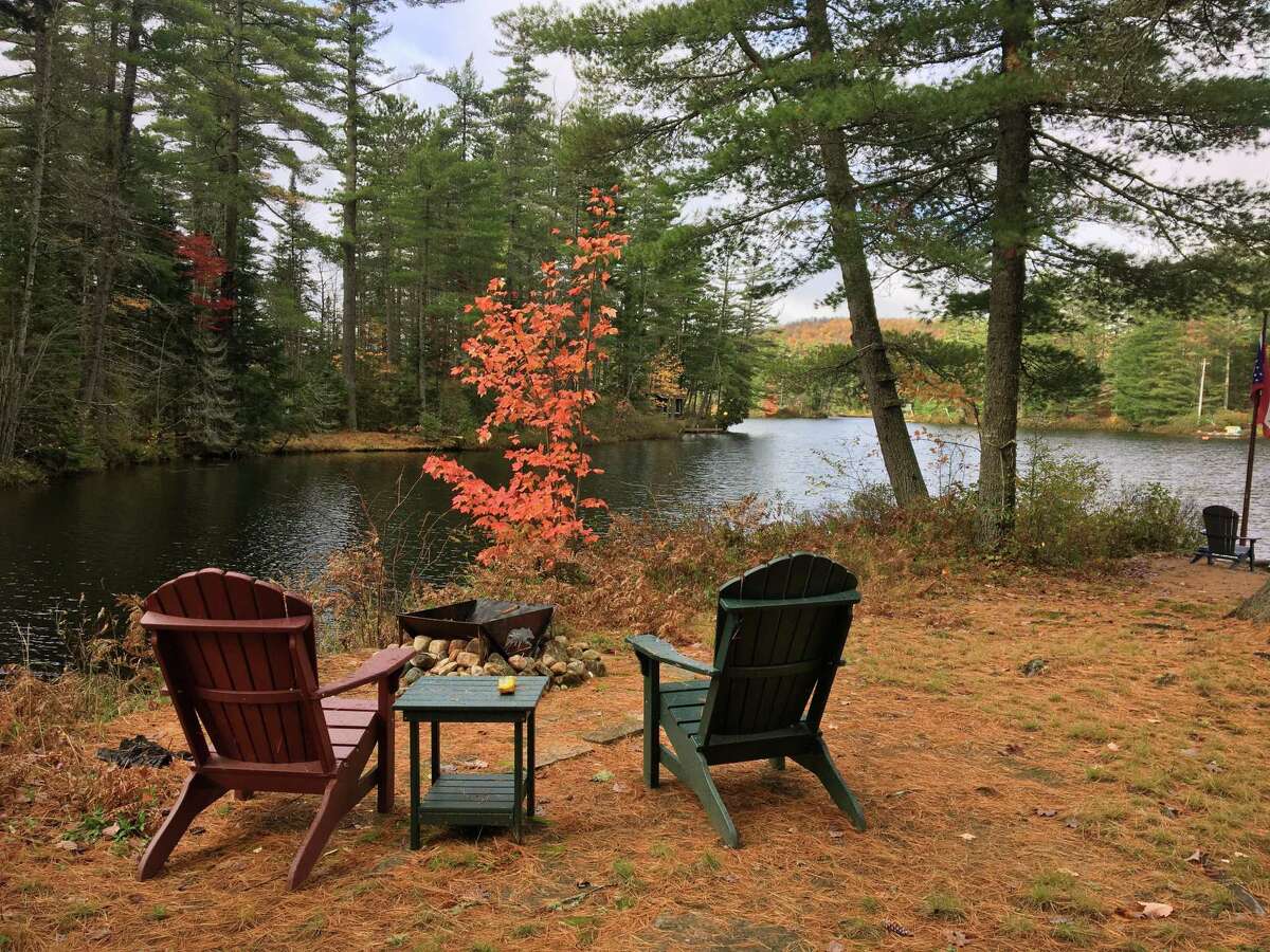 Looking out over Rainbow Lake, with Adirondack chairs in the Adirondacks.