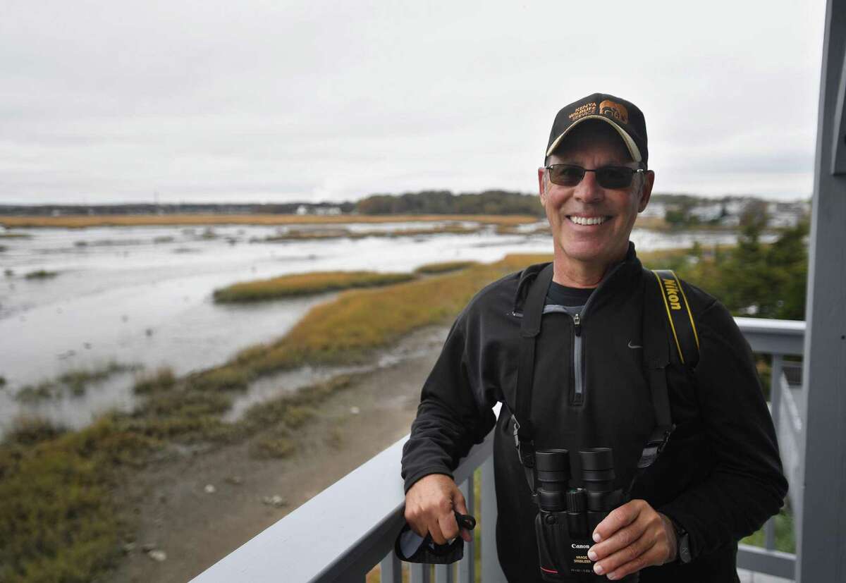 Board of Advisors member George Amato observes birds for a regular bird count at the Connecticut Audubon Coastal Center in Milford on Wednesday, October 28, 2020. The center is celebrating its' 25th anniversary.