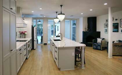 A view of the 12-foot long quartz island and the two pendant light fixtures in the kitchen. The lights orginally hung in the living room.